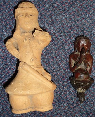 Lot 286 - A South American Terracotta Lintel Post Finial, modelled as a man standing with one hand raised...