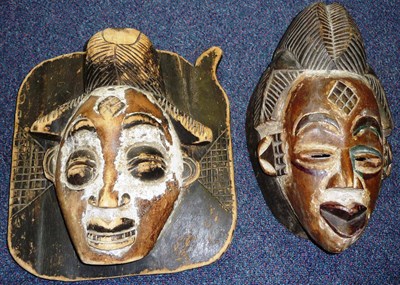 Lot 296 - A Gaboon Wood Mask, with high combed coiffure, diamond scarification to the forehead, arched...