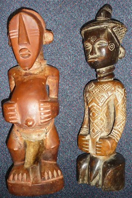 Lot 298 - An Ndengese Wood Figure of a Man, with top knot to his diapered coiffure, double ring neck and...