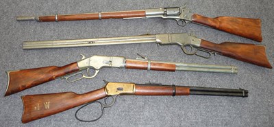 Lot 414 - A Replica of a Colt Six Shot Revolving Rifle; three Replica Winchester Rifles, all with wood...