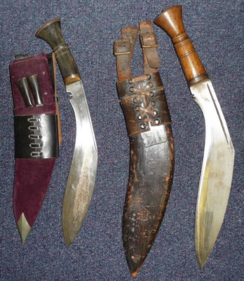 Lot 129A - An Indian Kukri, the blade stamped Tempered Steel, India, with wood grip, leather scabbard and...