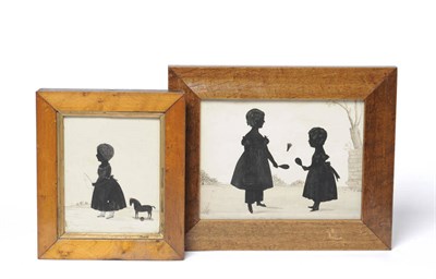 Lot 1080 - A Silhouette Group of Two Young Girls Playing Battledore, circa 1840, with faint detail in gilt, in