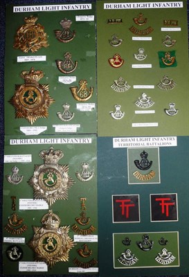 Lot 67 - The Durham Light Infantry - a collection of thirty seven helmet plates, cap badges, shoulder titles