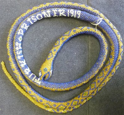 Lot 94 - A First World War Turkish Prisoner of War Beadwork Snake, worked in blue and amber glass beads...