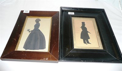 Lot 1088 - A Silhouette Cutout Standing Portrait of a Lady, circa 1840, her hair in a bun and ringlets,...