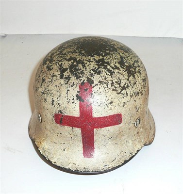 Lot 119 - A Second World War German M40 Combat Helmet for a Medic, the white painted skull bearing traces...