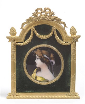 Lot 1092 - A Limoges Enamel Miniature Portrait Plaque, circa 1910, circular, depicting a young beauty,...