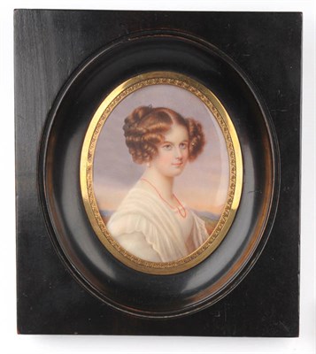 Lot 1094 - English School, circa 1900: Portrait Miniature of a Young Woman, bust length, turning to...