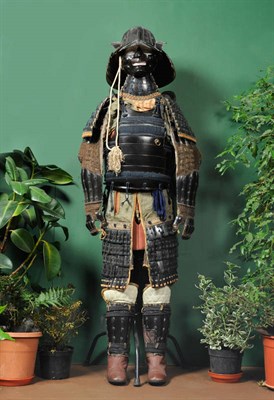 Lot 207 - A Japanese Gosuko (Suit of Armour), of black lacquered metal and green floral silk brocade,...