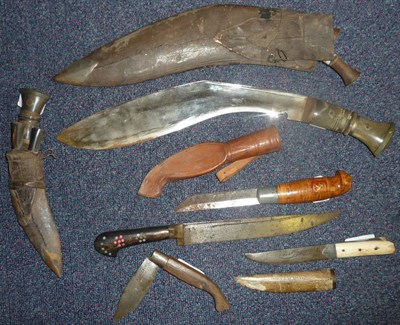 Lot 234 - A Kukri, with horn grip, leather scabbard with two small knives; a Similar Smaller Kukri; an Indian