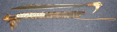 Lot 285 - A Dyak Head Hunter's Sword (Mandau), the 60.5cm single edge steel blade with pierced scroll...