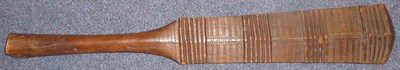 Lot 296 - A Tongan War Club, the cricket bat type head with four graduated  panels, each carved with a series