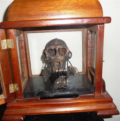 Lot 307 - An Indonesian Witch Doctor's Monkey Skull, with dark stained decoration, each cheek bone...