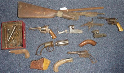 Lot 382 - Three Belgian Pinfire Revolvers, one lacking grip; a gun stock and a quantity of gun parts...