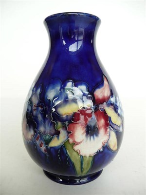 Lot 1131 - A Walter Moorcroft "Orchid and Spring Flowers" Baluster Vase, on a blue ground, impressed...