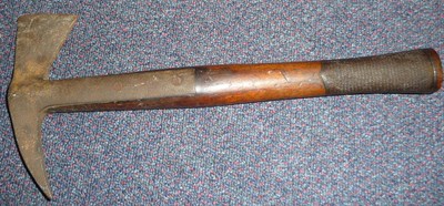 Lot 157 - A 19th Century Fire Axe, the socket head with long langets on a walnut haft with chequered grip.