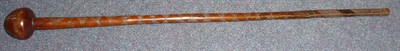 Lot 222 - A Zulu Knobkerrie, the bulbous head incised with a band of chevrons and scrolls, the tapering...