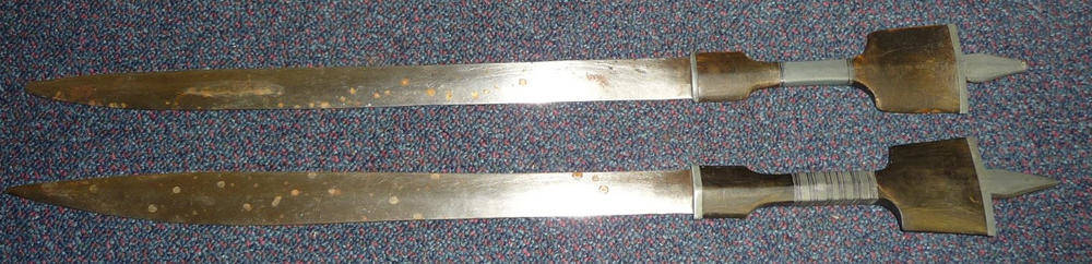 Lot 238 - Two Very Similar Sudanese Swords, each with double edge slightly swollen steel blade,...