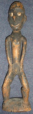 Lot 243 - A West African Wood Figure of a Man, standing with inset shell eyes, nose with pierced nostrils and