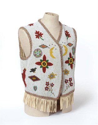 Lot 259 - A North American Indian Beadwork Waistcoat, the white beadwork field worked with flowerheads, maple