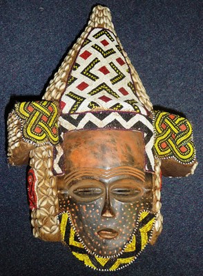 Lot 268 - A Kuba Janus Helmet Mask, Congo, each wood face with red dotted decoration, wearing a high...