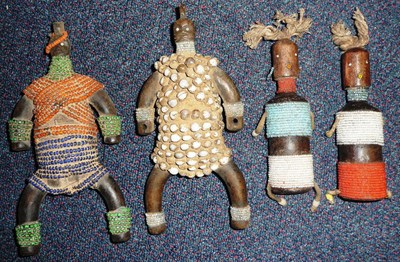 Lot 273 - A Collection of Four Nanji Wood Dolls, Cameroon, two with rounded bodies, outstretched arms and...