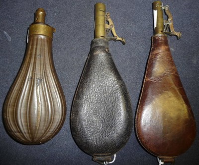 Lot 285 - A Copper Powder Flask, of fluted pear shape, with brass charger; two Leather Shot Flasks, with...