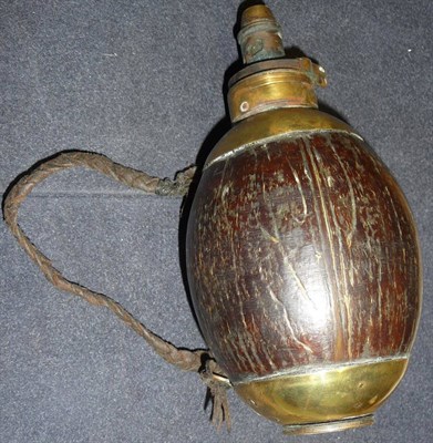 Lot 295 - A 19th Century Coconut Shell Powder Flask, with brass mounts to the shoulders and base, brass...