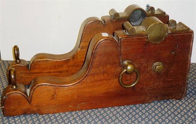 Lot 365 - An Oak Gun Carriage, the shaped and stepped side pieces set with brass hinged and pegged panels for