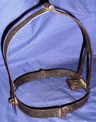 Lot 85 - A 19th Century Scold's Bridle, hinged in three places, 26cm high, 17cm wide.