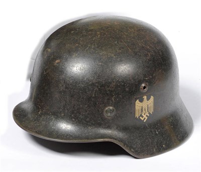 Lot 86 - A German Third Reich M1935 Army Helmet, with double decals of Heer eagle and swastika and tricolour