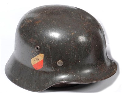 Lot 90 - A German Third Reich M1935 Luftwaffe Helmet, with double decals of Luftwaffe eagle and...