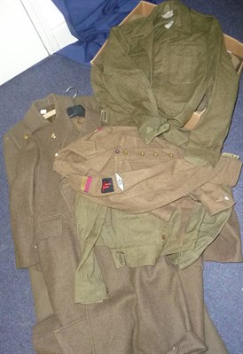 Lot 96 - A Collection of Army Uniforms, comprising three greatcoats, four battledress blouses and two...