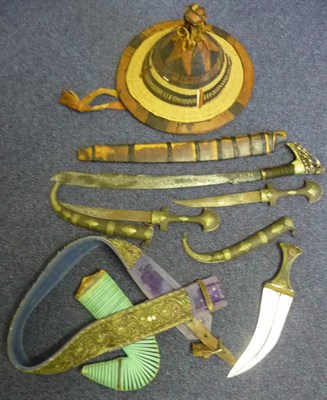 Lot 165 - An Arab Jambiya, the curved blade with central medial ridge, horn grip, green raffia bound...