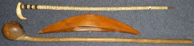 Lot 173 - A Zulu Knobkerrie, with large offset bulbous head on a long cylindrical haft, of pale colour, 98cm