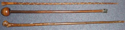 Lot 175 - A Zulu Knobkerrie, with small globular head and tapering haft; two Wood Walking Canes, one with...