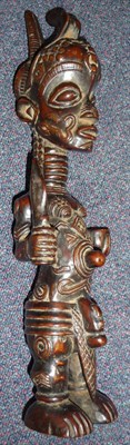 Lot 195 - A Bena Lolua Wood Figure, Congo, standing holding a dagger and a cup, with high shaped...