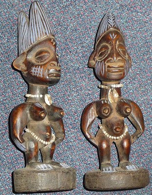 Lot 200 - A Pair of Yoruba, Nigeria Ibeji, both female, each with high combed coiffure, standing with...