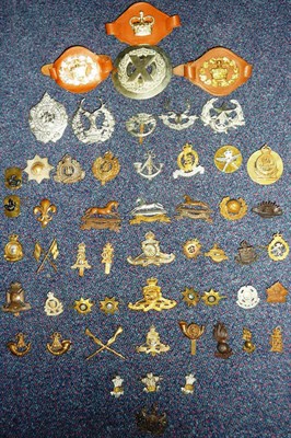 Lot 71 - A Collection of Fifty Military Cap Badges, in brass and white metal, a white metal plaid brooch and