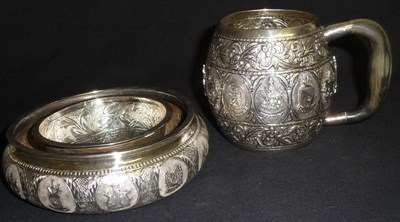 Lot 109 - A Kelantan Silver Mug, of barrel shape, chased and repousse with bands of scrolling foliage...