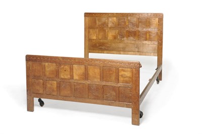 Lot 1205 - A Robert "Mouseman" Thompson Oak 4'6" Panelled Bedstead, the panelled headboard with...