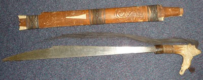 Lot 268 - A Dyak, Borneo Mandau (Head Hunter's Sword), the single edge steel blade with shaped tip, inset...