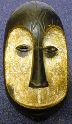 Lot 309 - A Lega, Congo Type Wood Helmet Mask, with domed forehead, dished heart shaped face decorated in...