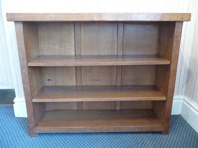 Lot 1217 - A Robert "Mouseman" Thompson Oak Low Bookcase, the adzed overhanging top above two adjustable...