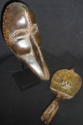 Lot 315 - A Dan, Ivory Coast Wood Bird Mask, the domed forehead, eyebrows and beak ridge set with metal...