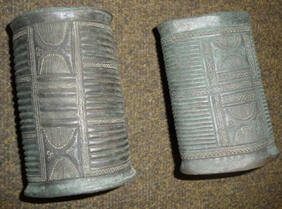 Lot 330 - A Brace of African Bronze Cuffs, possibly Benin, of split cylindrical form, each with folded...