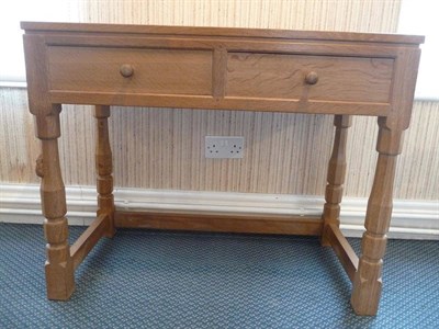 Lot 1237 - A Robert "Mouseman" Thompson Oak Hall Table, the rectangular top with two drawers below, on...