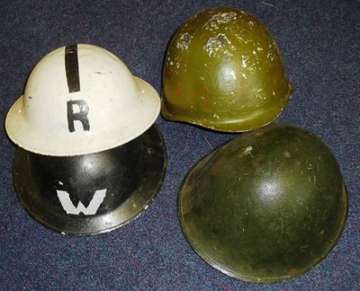 Lot 131 - Two Second World War Brodie Type Home Front Helmets, one painted black with W in white, the...