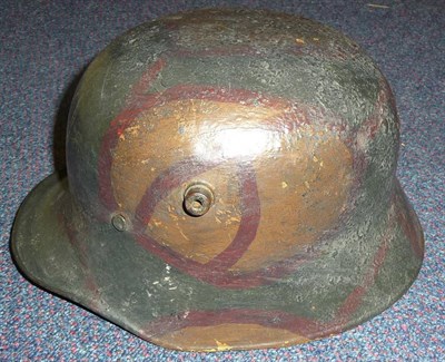 Lot 132 - A German M17 Camouflage Helmet, with rolled edge, leather liner and chinstrap