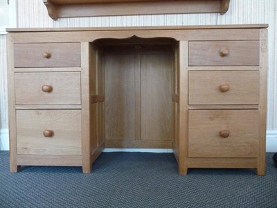 Lot 1247 - A Leon "Owlman" Keogh Panelled Oak Kneehole Desk, the rectangular top above three graduating...